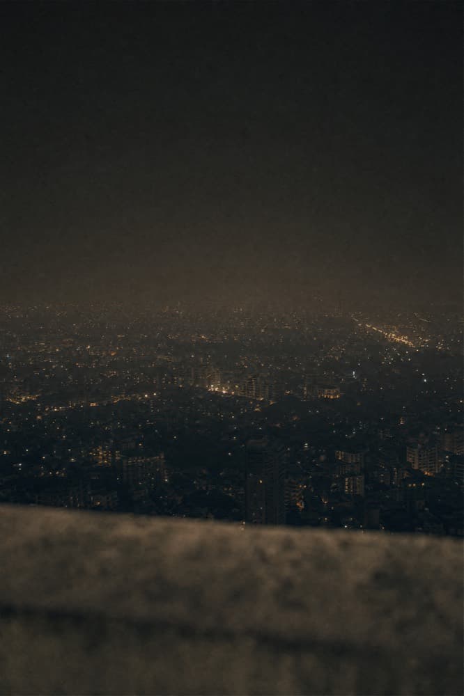 City lights seen from a high window at night.